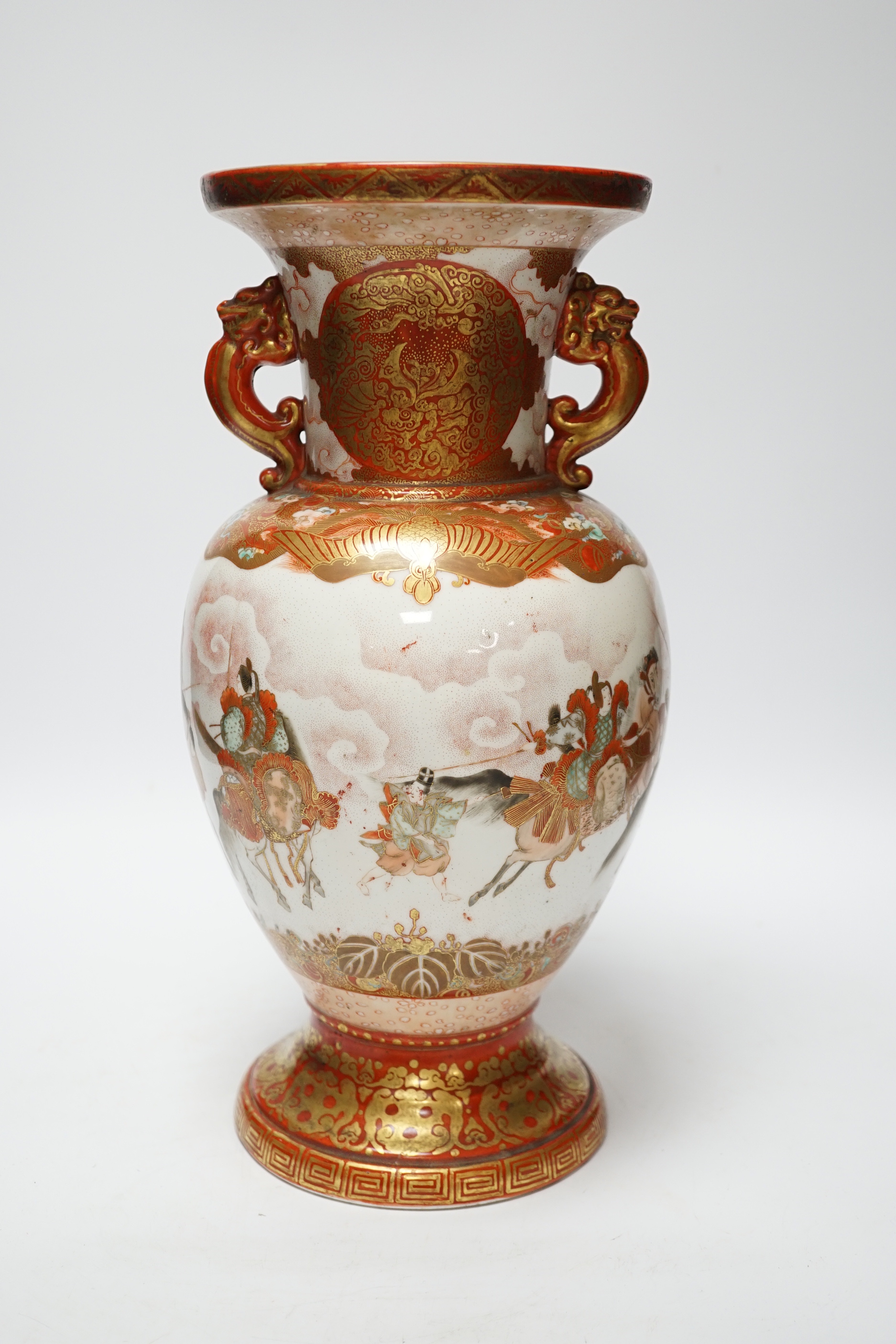 A Japanese Kutani porcelain twin handled vase, Meiji period, decorated with warriors on horseback, 34.5cm high